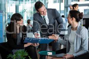 Businesspeople discussing over document