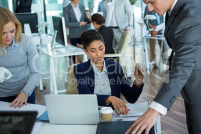 Businesspeople discussing over document