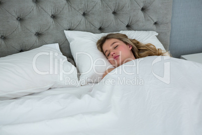 Young woman sleeping on her bed