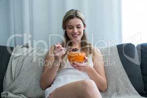 Woman having breakfast in living room