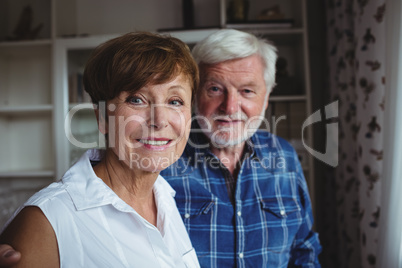 Senior couple smiling in living room