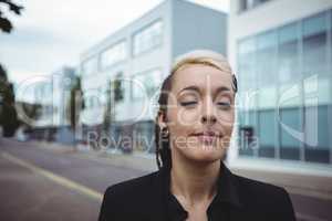 Businesswoman standing with eyes closed