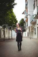 Woman using mobile phone while walking on street