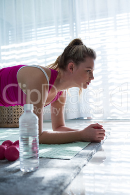 Woman doing exercise in living room