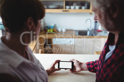 Senior couple using mobile phone