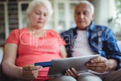 Senior couple doing online shopping on digital tablet