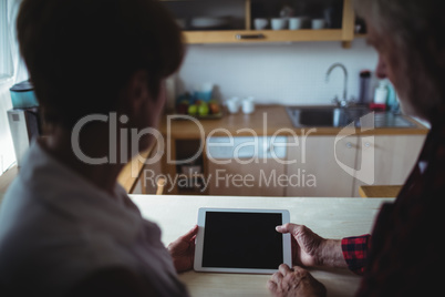 Senior couple using digital tablet