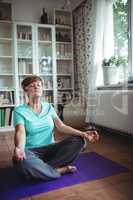 Senior woman meditating in lotus position
