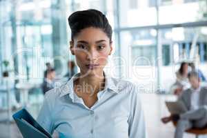 Businesswoman holding file in office