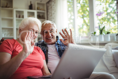 Senior couple video chatting on laptop