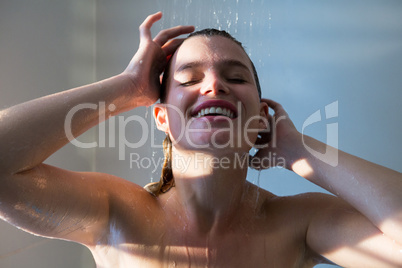 Woman taking a shower in bathroom