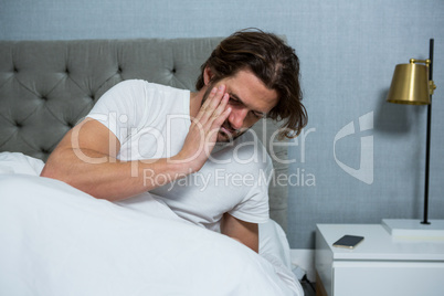 Man waking up from sleep in bedroom