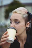 Close-up of businesswoman having coffee