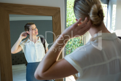 Woman getting ready for office in bedroom