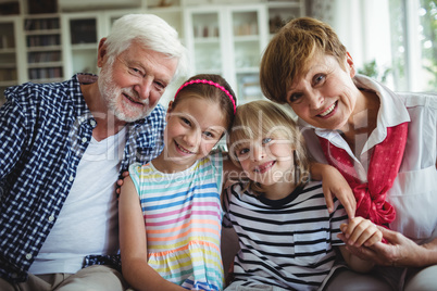 Portrait of grandparents sitting with their grandchildren