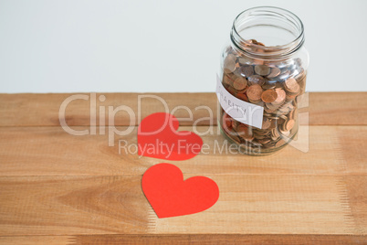 Close-up of coins in bottle and heart