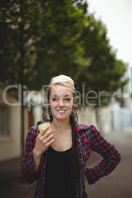 Woman standing with coffee cup