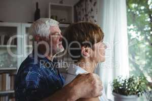 Senior couple looking through window