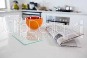 Breakfast bowl with coffee mug and newspaper