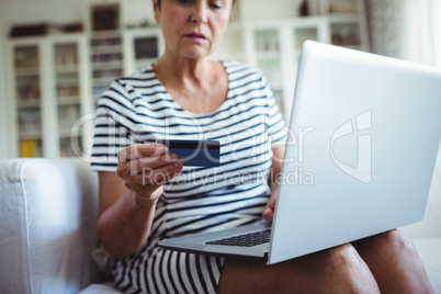 Senior woman doing online shopping on laptop