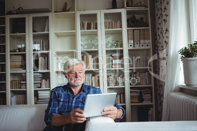 Senior man using digital tablet