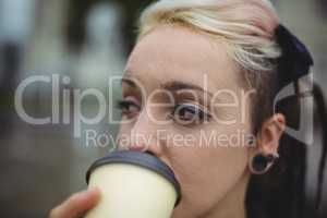 Close-up of businesswoman having coffee