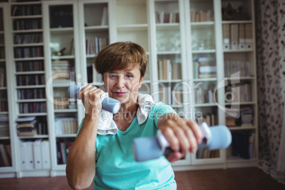 Senior woman exercising with dumbbells