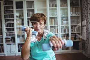 Senior woman exercising with dumbbells