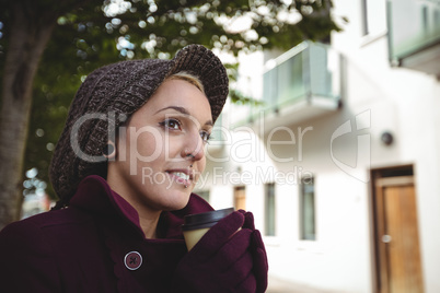 Woman smiling and holding a cup of coffee