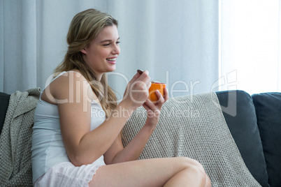 Woman having breakfast in living room