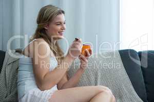 Woman having breakfast in living room