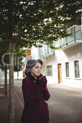 Woman smiling and holding a cup of coffee