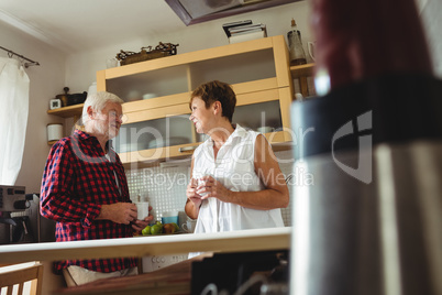 Senior couple interacting while having coffee