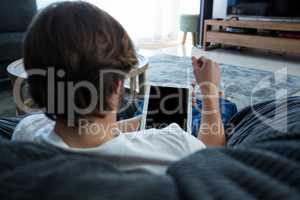 Man using digital tablet in living room