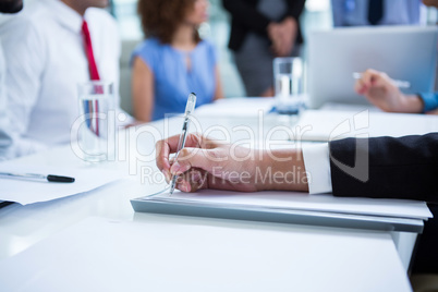 Businessman writing notes in office