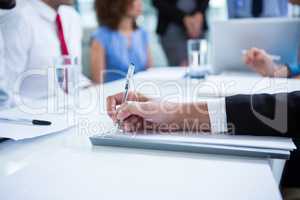 Businessman writing notes in office