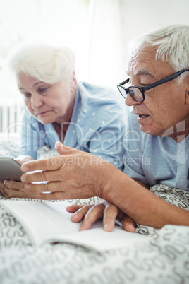 Senior couple interacting with each other on bed Senior couple interacting with each other on bed