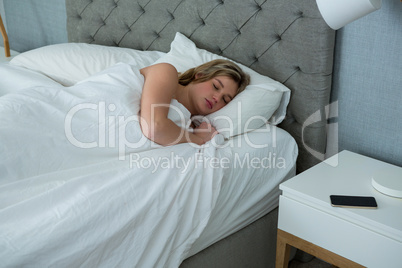 Young woman sleeping on her bed