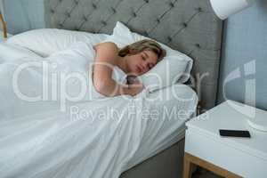 Young woman sleeping on her bed