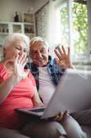 Senior couple video chatting on laptop
