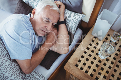 Senior man sleeping on bed