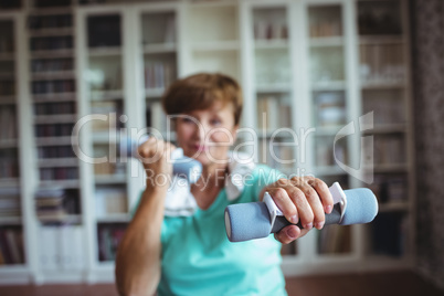 Senior woman exercising with dumbbells