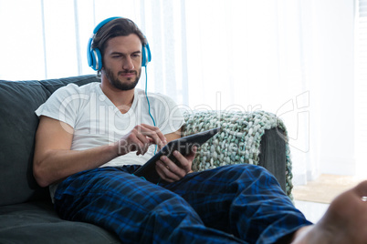 Man using digital tablet in living room