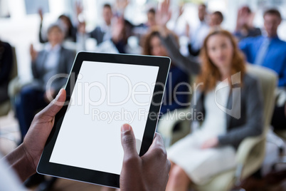 Businessperson using digital tablet during meeting
