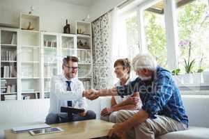 Financial advisor shaking hands with senior man