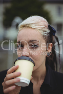 Portrait of businesswoman having coffee