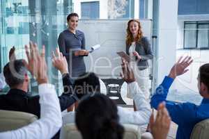 Colleagues raising their hands during meeting