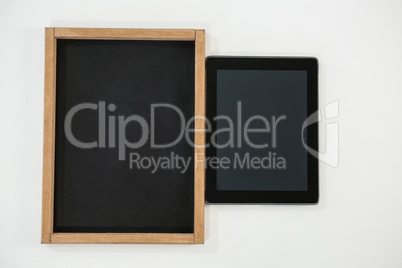 Digital tablet and slate on white background