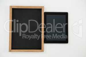 Digital tablet and slate on white background