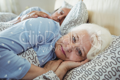 Senior woman awake on bed